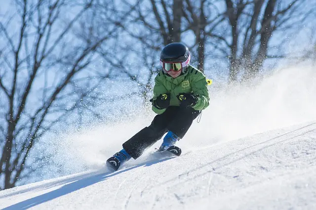 A boy skiing down a hill.